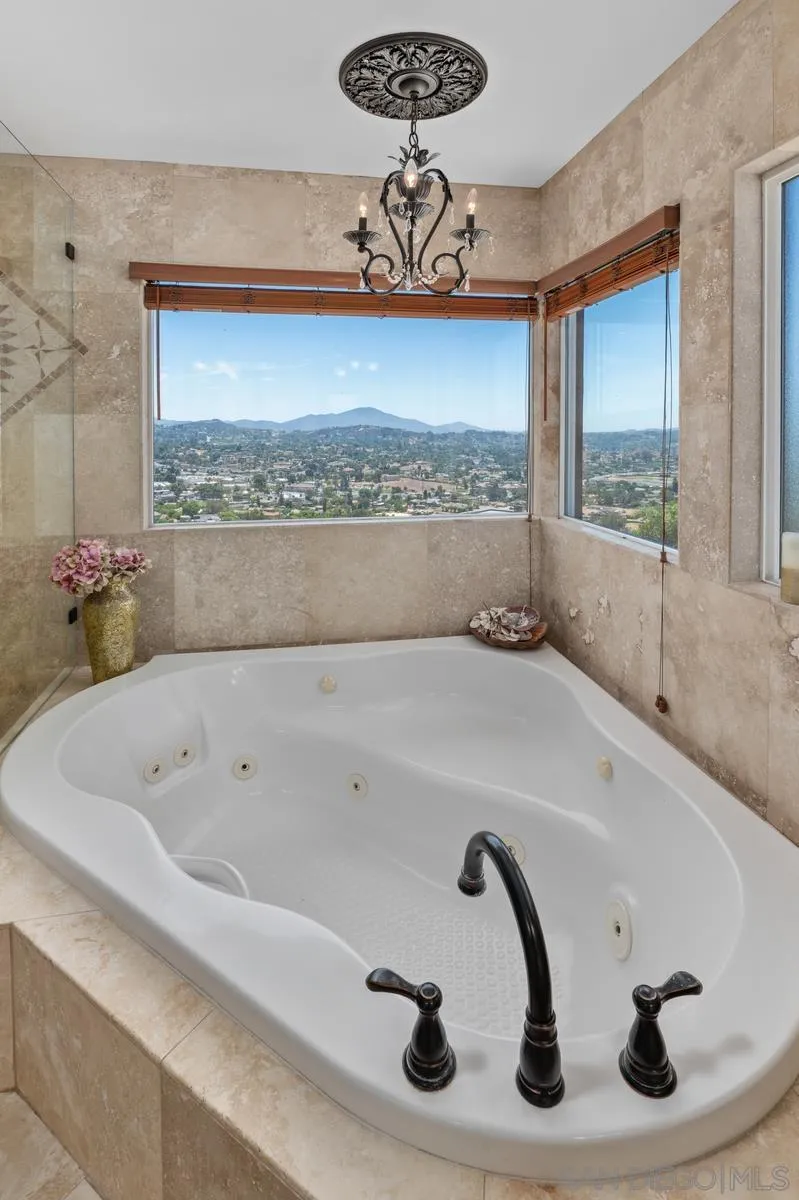 2155 Vista Valley Rim Place El Cajon, CA 92019 - Photo 24 of 61 a bathroom with a tub and a large window
