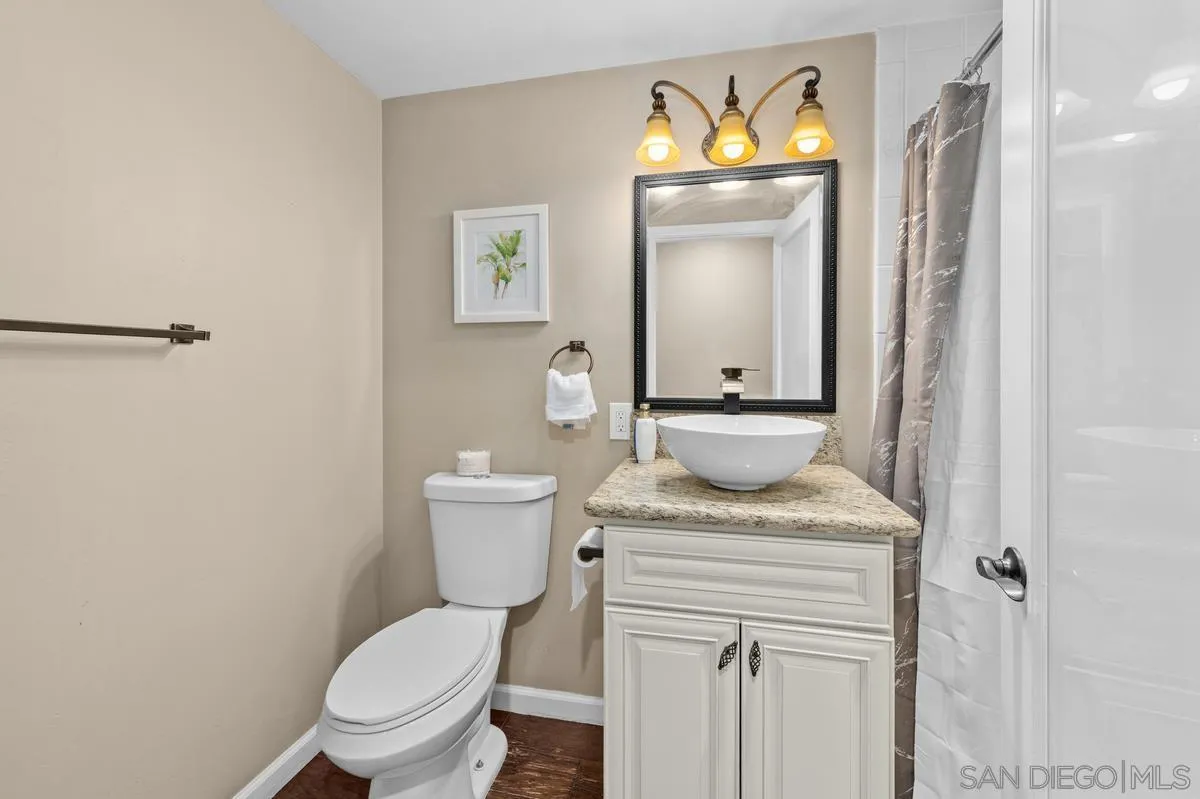 2155 Vista Valley Rim Place El Cajon, CA 92019 - Photo 31 of 61 a bathroom with a granite countertop toilet sink and mirror