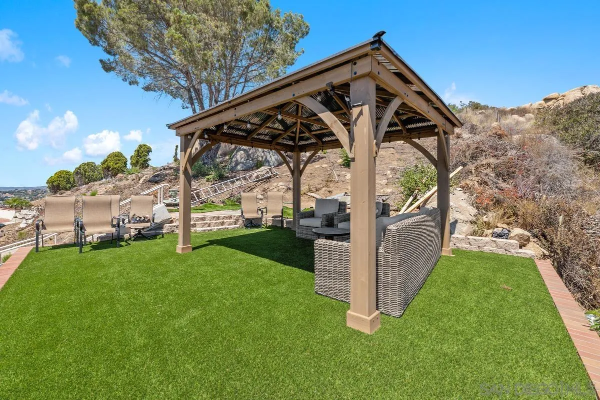 2155 Vista Valley Rim Place El Cajon, CA 92019 - Photo 35 of 61 a view of a tiny house with a big yard and large trees