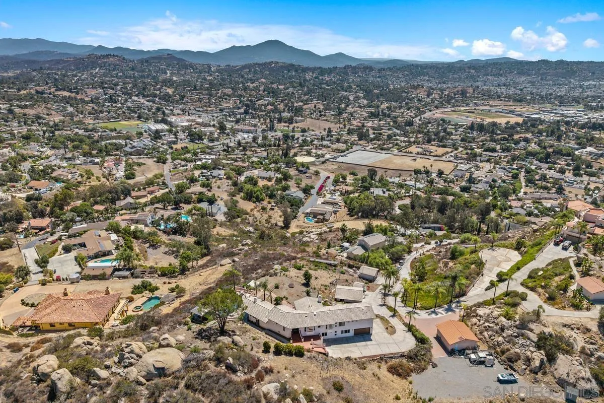 2155 Vista Valley Rim Place El Cajon, CA 92019 - Photo 40 of 61 an aerial view of a house with a yard and mountain view in back
