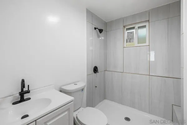 a view of a kitchen with white cabinets and wooden floor