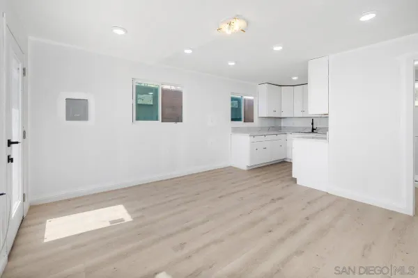 a view of a patio with table and chairs with wooden floor and fence
