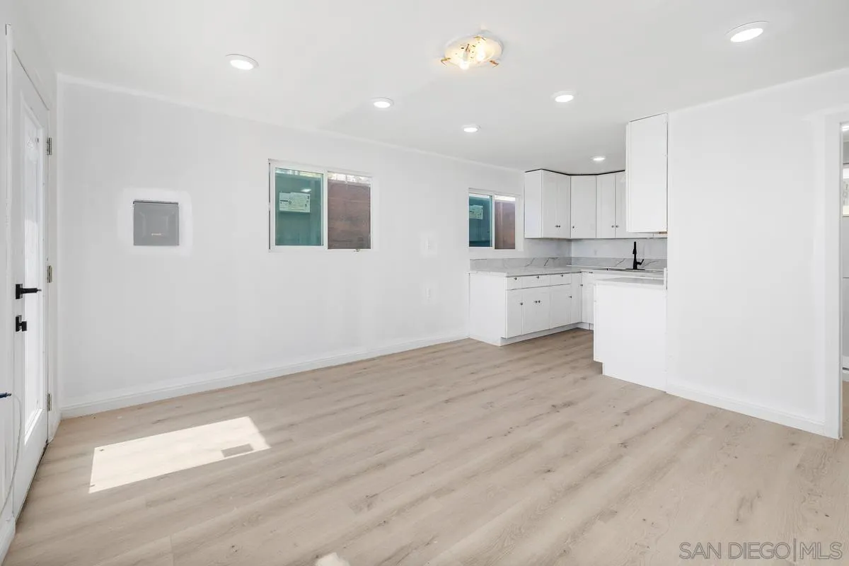 2155 Vista Valley Rim Place El Cajon, CA 92019 - Photo 50 of 61 a view of a kitchen with white cabinets and wooden floor