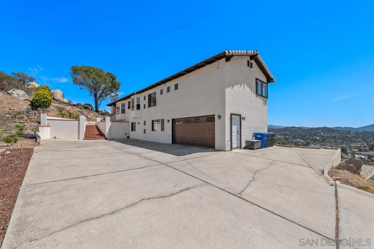 2155 Vista Valley Rim Place El Cajon, CA 92019 - Photo 5 of 61 a very nice looking house with a large parking space and a large tree