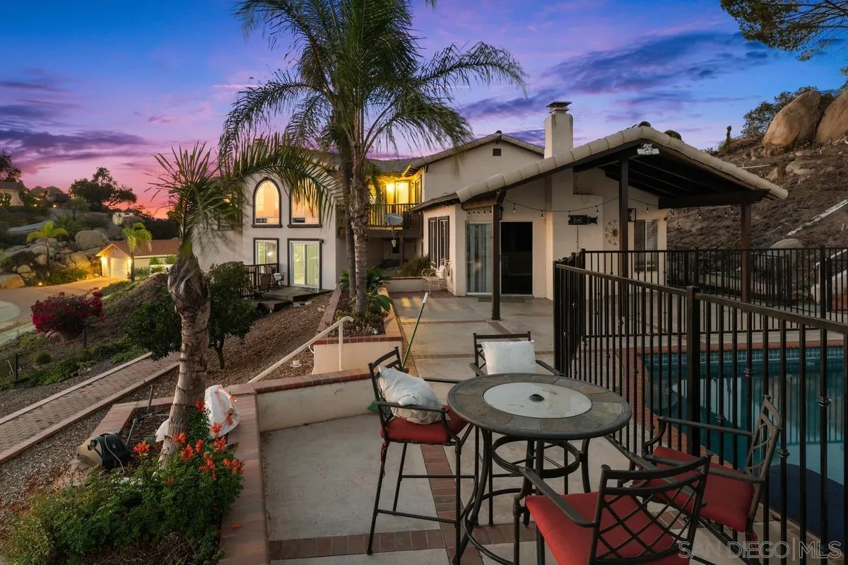 2155 Vista Valley Rim Place El Cajon, CA 92019 - Photo 60 of 61 a view of a patio with table and chairs with wooden floor and fence