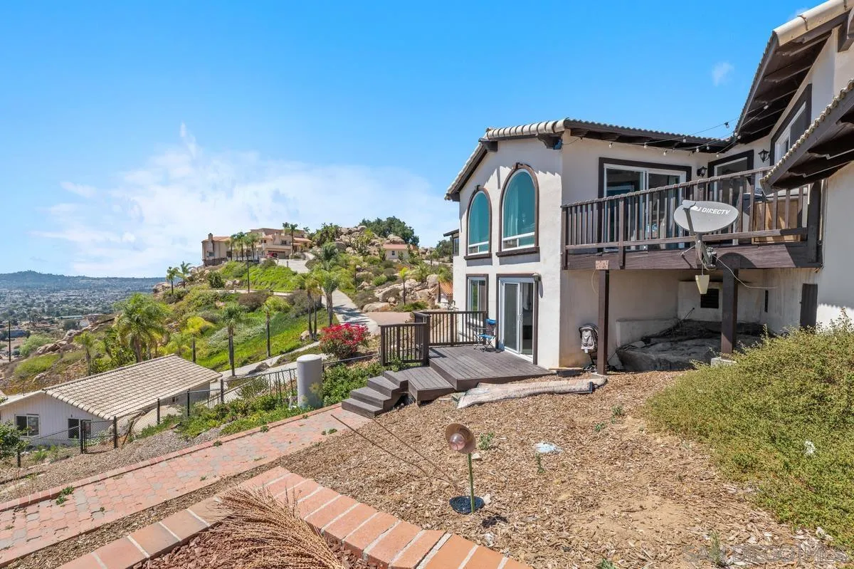 2155 Vista Valley Rim Place El Cajon, CA 92019 - Photo 6 of 61 a view of a house with a small yard and plants