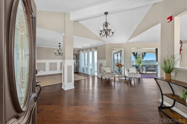 a view of a livingroom with furniture wooden floor and a chandelier