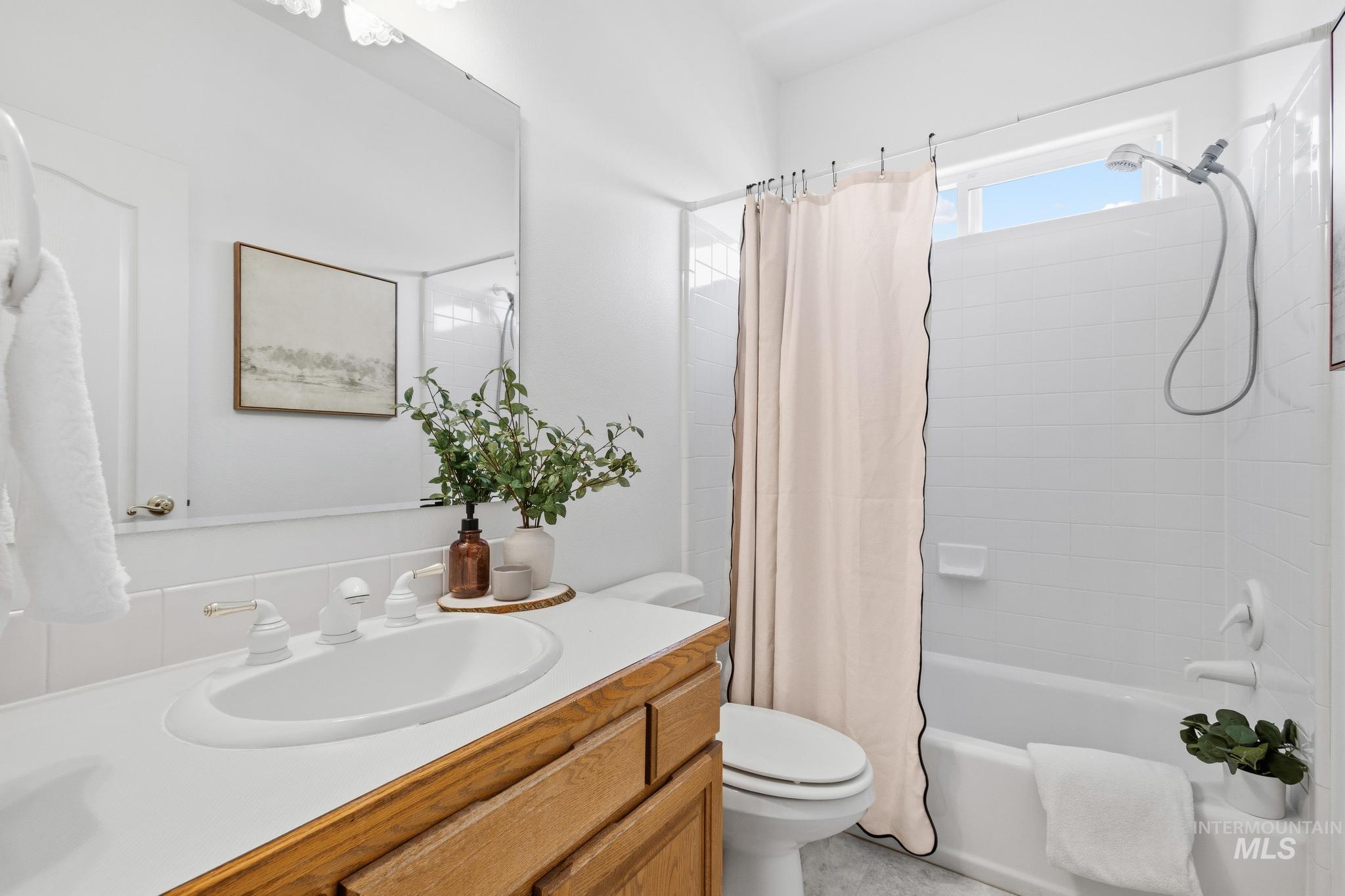 15181 Drury Way Caldwell, ID 83607 - Photo 28 of 49 Bathroom featuring a wood-finish vanity with a white countertop and undermount sink