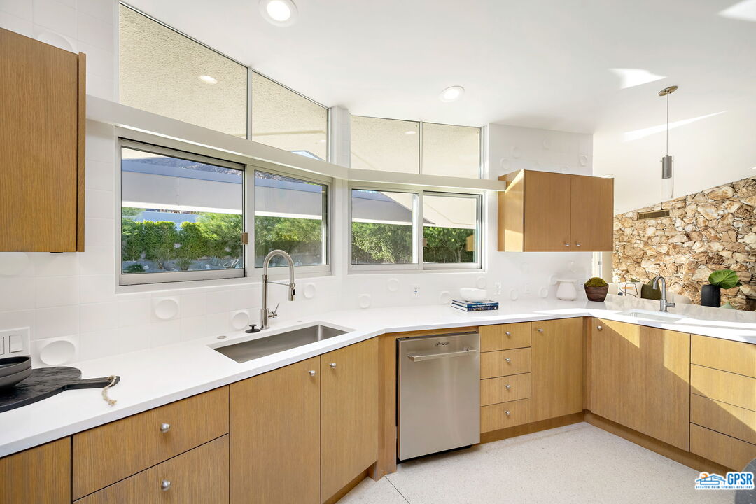 1350 Ladera Circle Palm Springs, CA 92262 - Photo 22 of 54 a kitchen with a sink window and cabinets