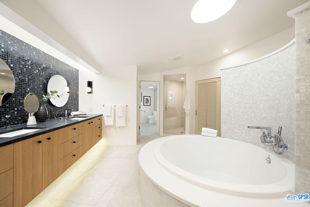 1350 Ladera Circle Palm Springs, CA 92262 - Photo 34 of 54 a spacious bathroom with a double vanity sink and a mirror