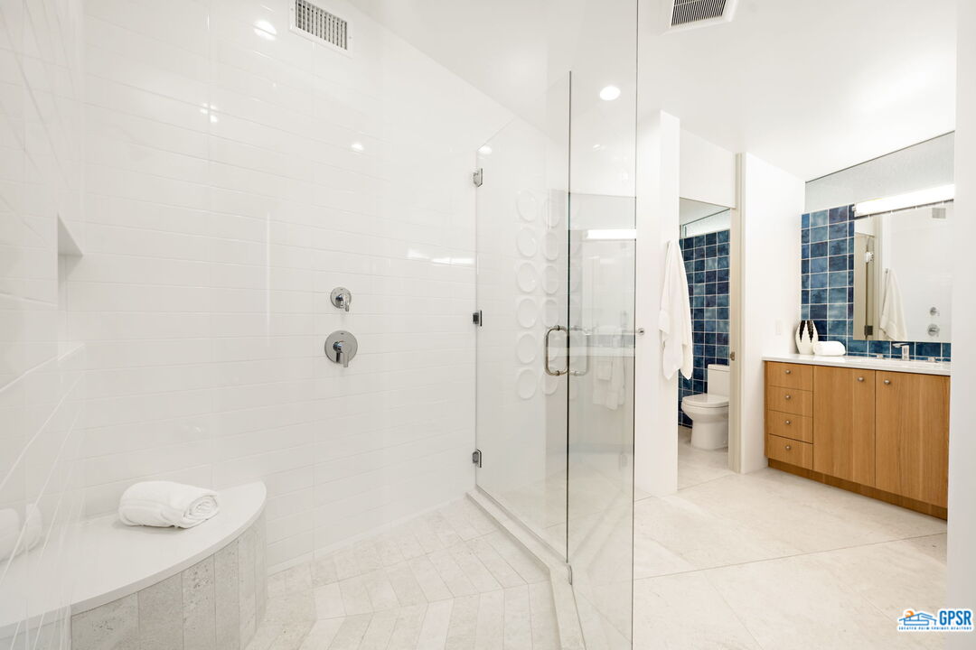 1350 Ladera Circle Palm Springs, CA 92262 - Photo 37 of 54 a bathroom with a double vanity sink a toilet and shower
