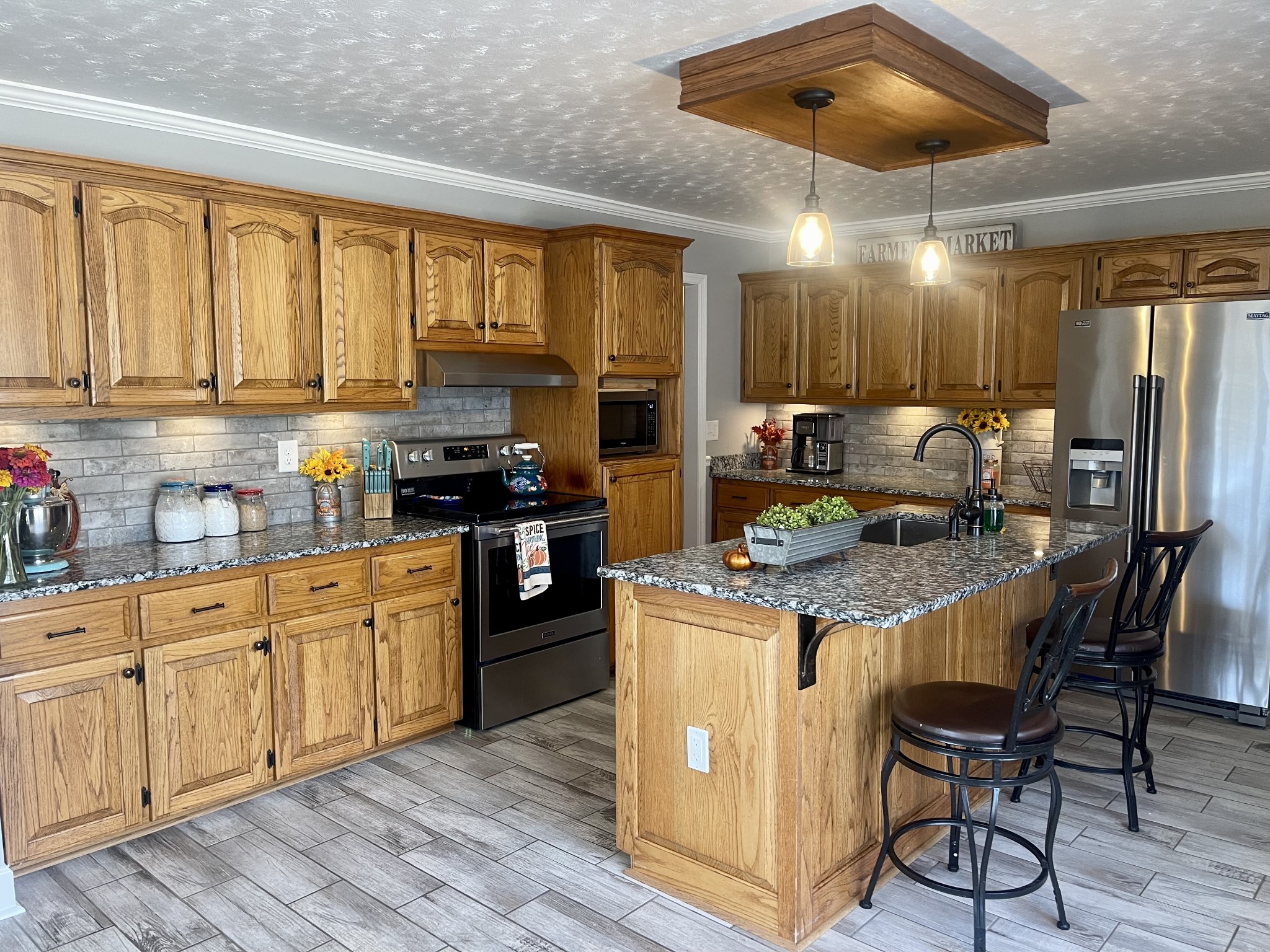 14 Aldridge Road Leoma, TN 38468 - Photo 12 of 50 a kitchen with stainless steel appliances granite countertop a stove top oven a refrigerator a sink and dishwasher with wooden floor