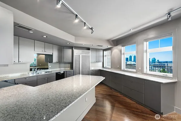 a large kitchen with granite countertop lots of counter top space