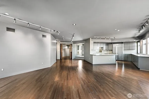 a view of a kitchen with cabinets and wooden floor