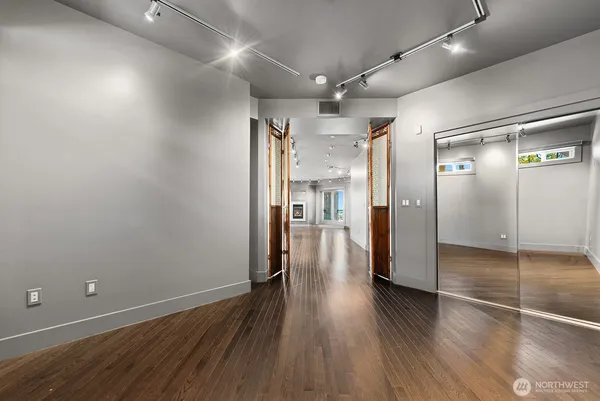 a view of a hallway with wooden floor