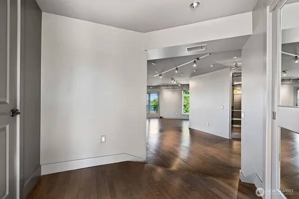 a view of empty room with wooden floor