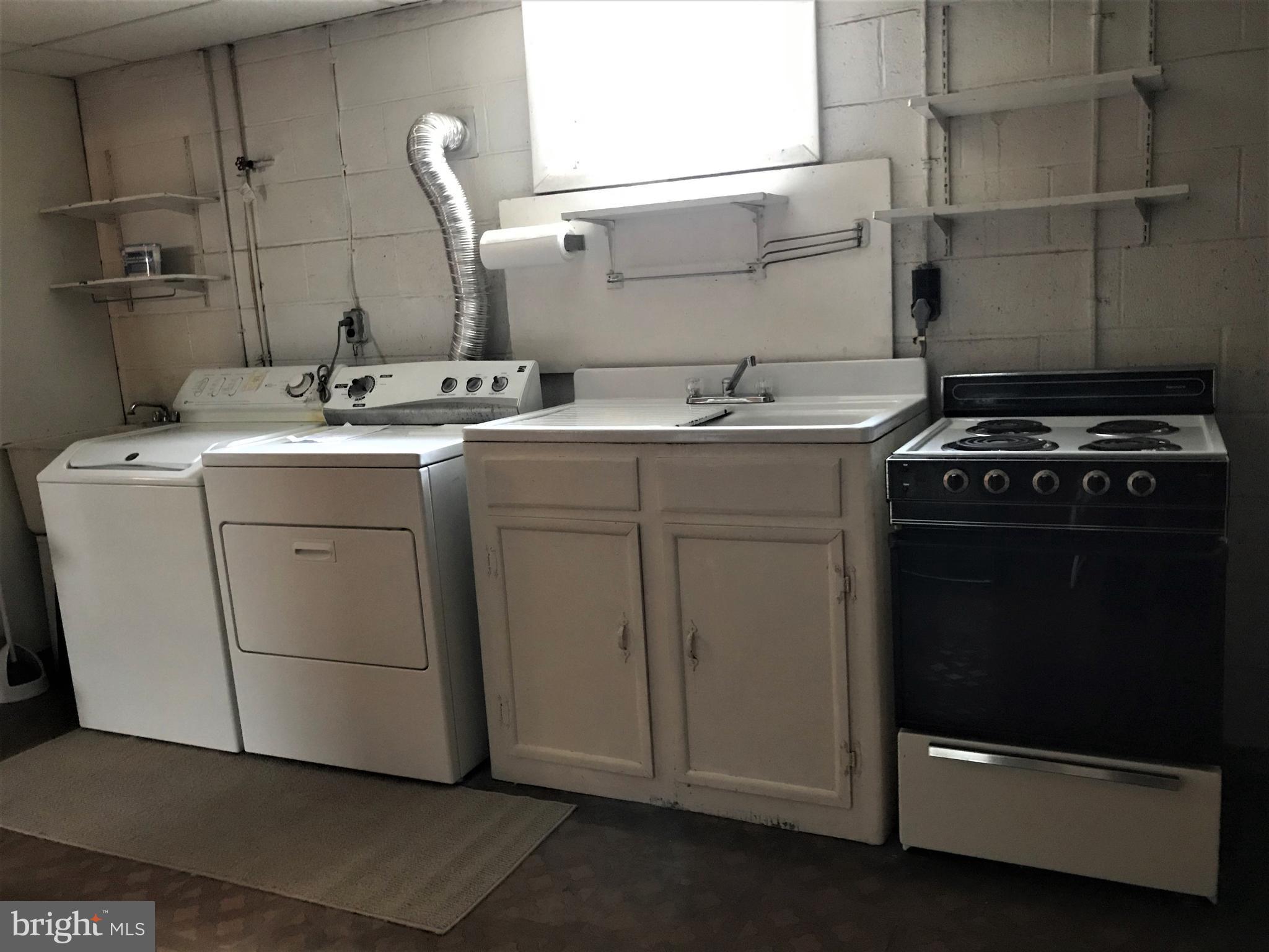 2306 Ruth Avenue Baltimore, MD 21219 - Photo 16 of 19 a utility room with cabinets washer and dryer