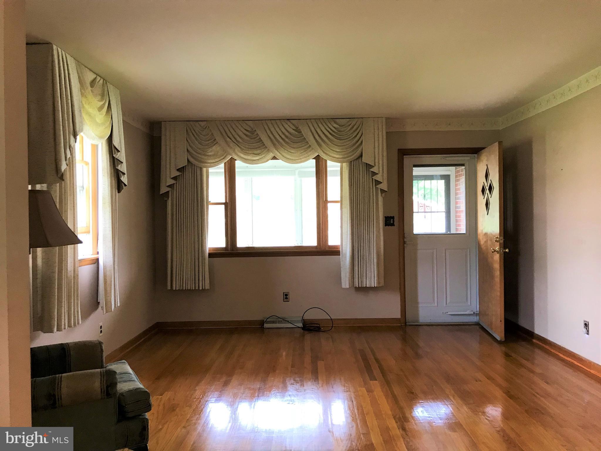 2306 Ruth Avenue Baltimore, MD 21219 - Photo 5 of 19 a view of empty room with wooden floor and fan