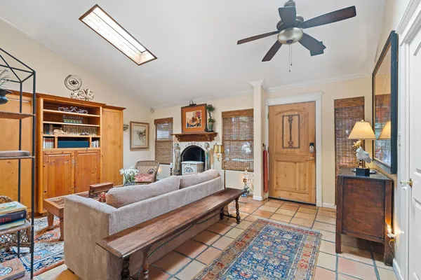 a living room with furniture a rug and a painting on the wall