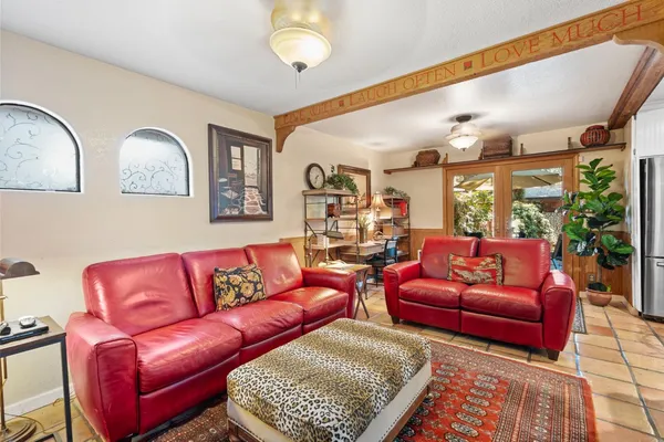 a living room with furniture wooden floor and a large window