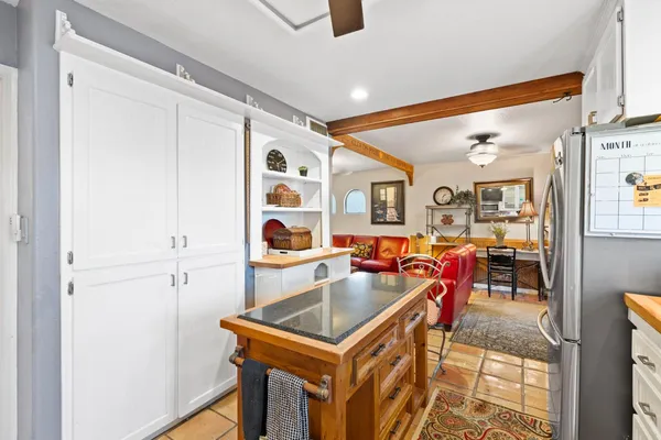 a kitchen with stainless steel appliances granite countertop a sink a stove and a refrigerator