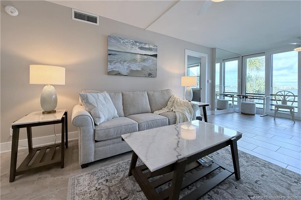 1950 Southwest Palm City Road, Unit 14305 Stuart, FL 34994 - Photo 14 of 70 a living room with furniture and wooden floor