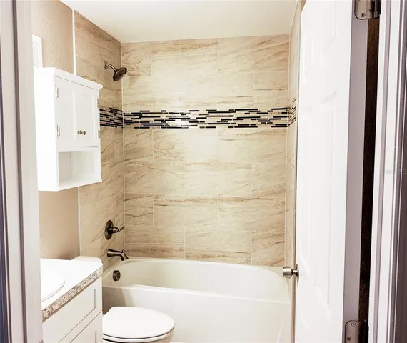 a bathroom with a shower a bathtub and toilet