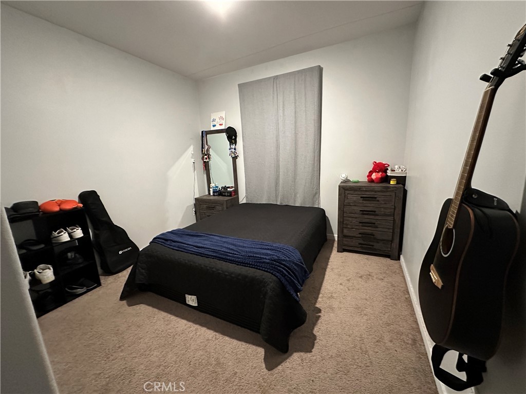 1351 Fiddleleaf Drive Banning, CA 92220 - Photo 7 of 16 a bedroom with a bed and cabinets