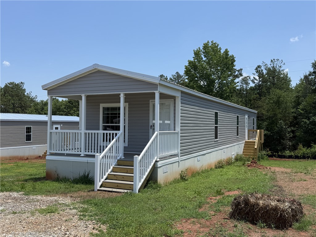 108 Candlestick Lane Seneca, SC 29678 - Photo 6 of 14 A welcoming front porch and sturdy stairs lead to this charming residential exterior.