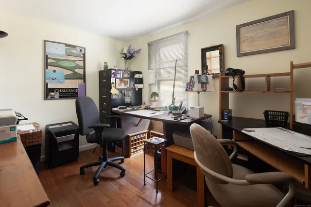 a view of a livingroom with workspace and a couch