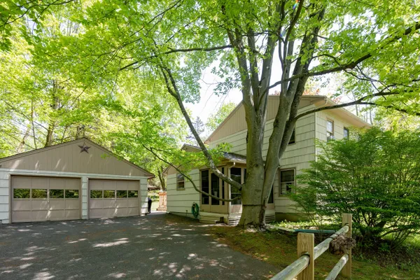 front view of a house with a tree in the background
