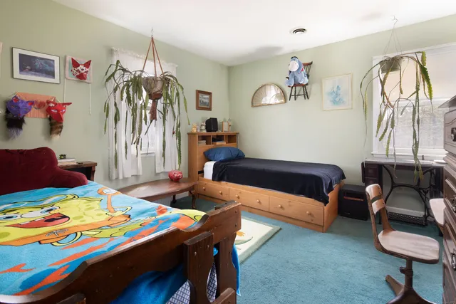 a bedroom with a bed and a couch