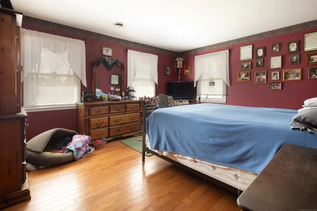 a bedroom with a bed and window