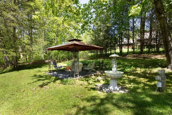 a backyard of a house with table and chairs