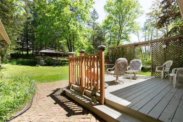 a view of a wooden floor and a bench in the garden