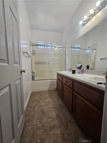 a bathroom with a granite countertop toilet and a sink
