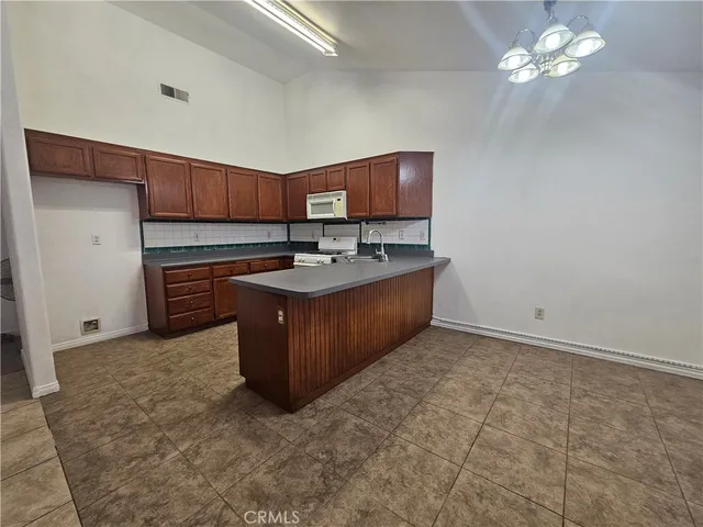 a kitchen with sink cabinets and stove top oven