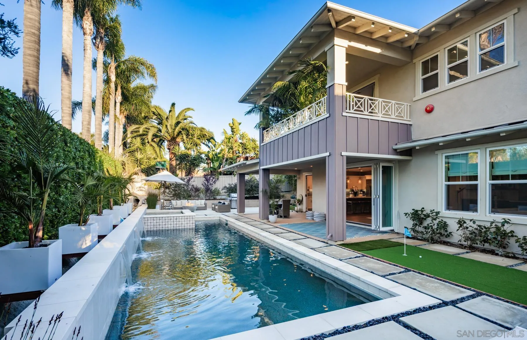 a view of a house with pool and chairs