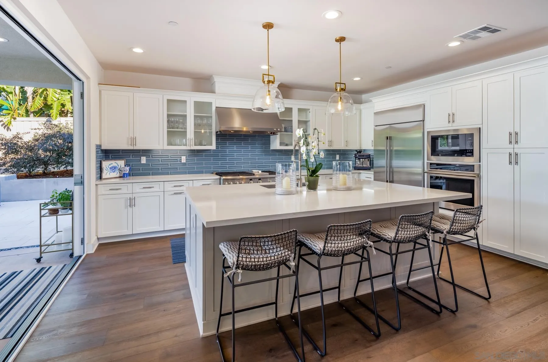 939 Moonstone Court Encinitas, CA 92024 - Photo 7 of 25 a kitchen with a sink a counter space appliances and cabinets