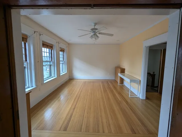 a view of a hallway view with wooden floor and staircase