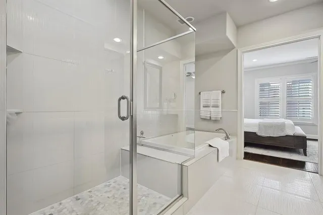 a spacious bathroom with a tub shower and sink