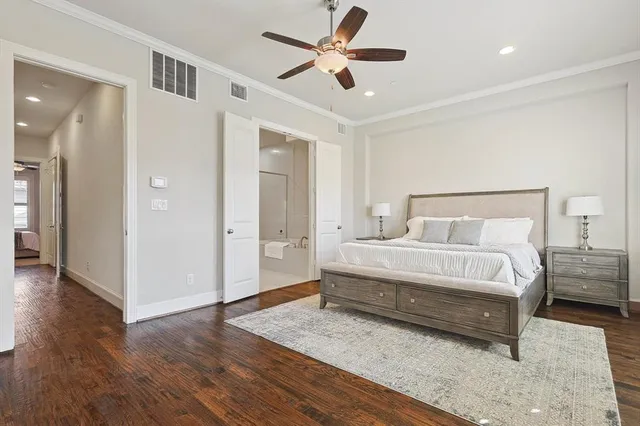 a spacious bedroom with a bed and a ceiling fan