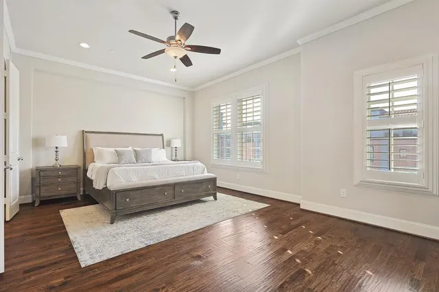 a bedroom with a large bed wooden floor and window