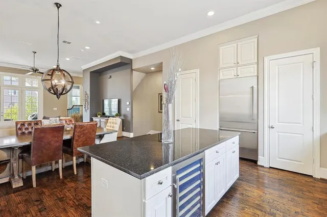 a large kitchen with a table and chairs