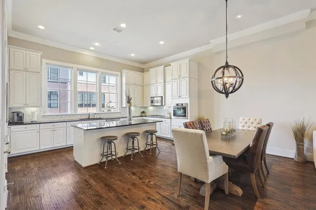 a large kitchen with a table and chairs in it