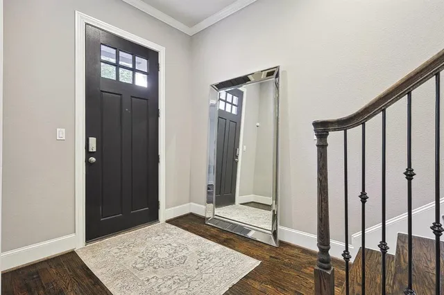 a view of a hallway with a white walls and stairs