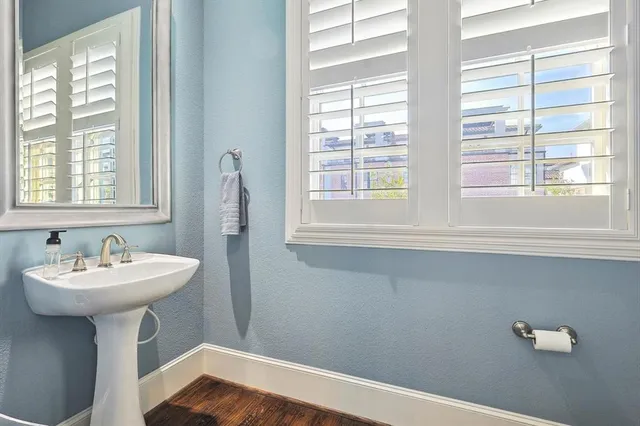 a bathroom with a sink a mirror and a window