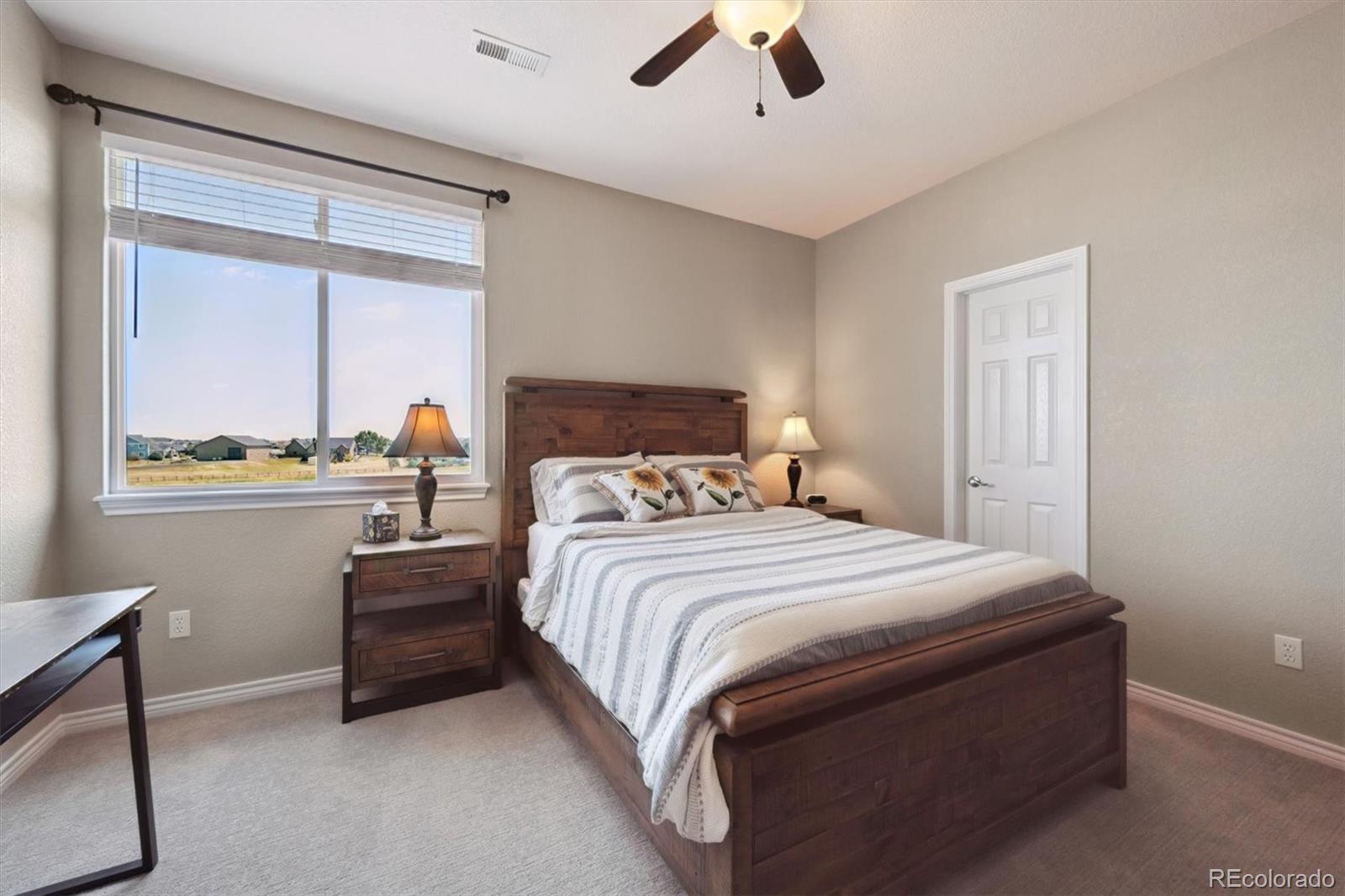 724 Imboden Road Watkins, CO 80137 - Photo 28 of 50 a bedroom with a bed and a window