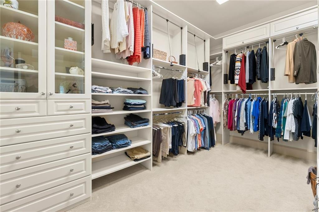 322 Edwards Brook Lane Canton, GA 30115 - Photo 43 of 99 a view of walk in closet with clothes and shoes