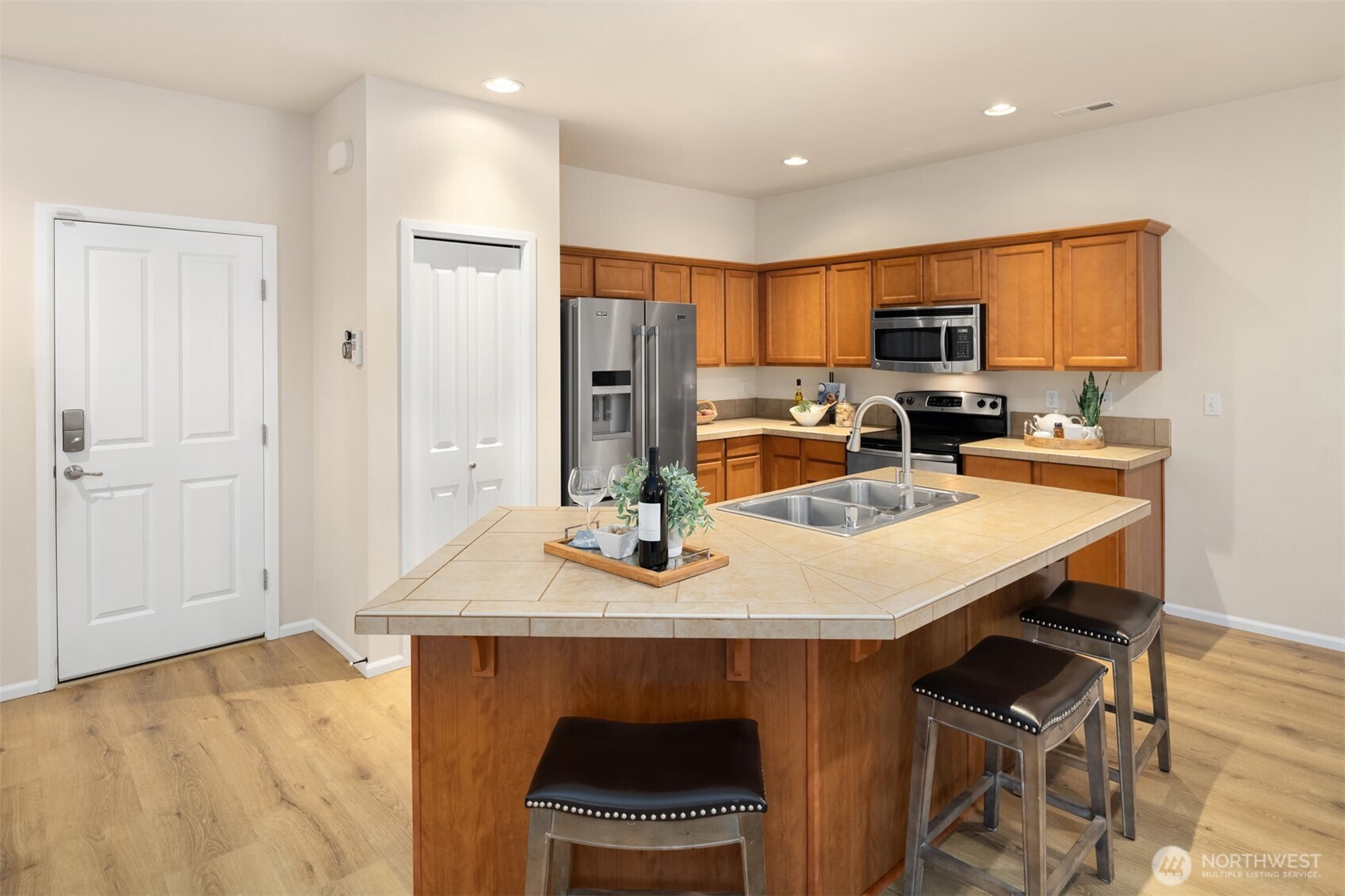 21272 Southeast 275th Court Maple Valley, WA 98038 - Photo 11 of 40 a kitchen with a sink a stove and chairs